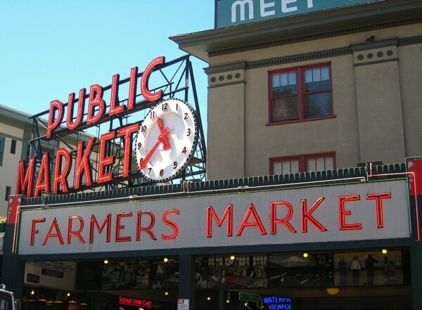 Pike Place, Seattle. Neon sign with a clock and "Public Market" above another neon sign reading "Farmers Market"