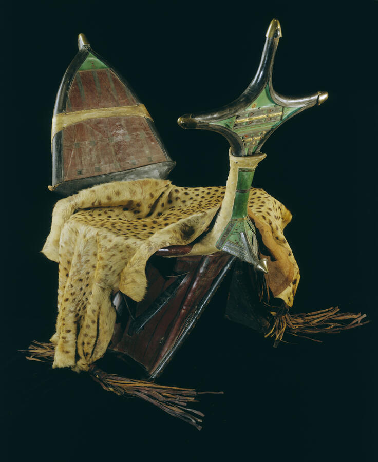 Saddle for a camel made from wood, metal, and cheetah skin.