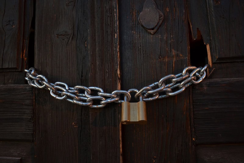 An old door chained shut.