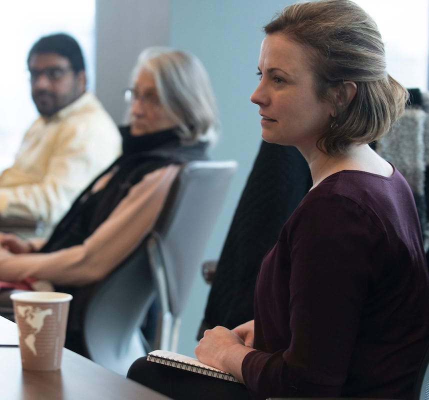 Woman sitting in conference room with a coffee