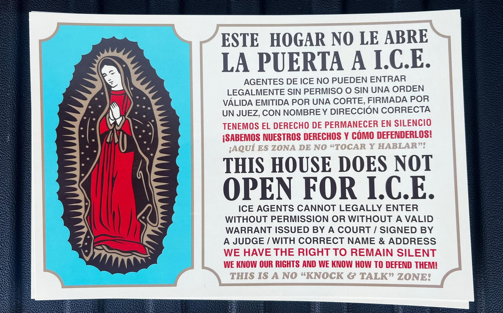 A flyer with a Catholic Saint on the lefthand side and the words THIS HOSE DOES NOT OPEN FOR I.C.E written in Spanish and English