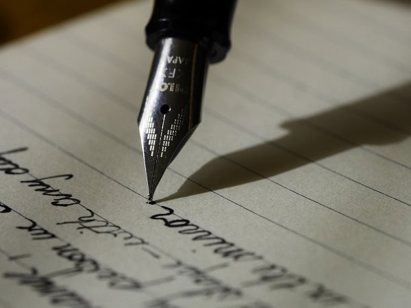 A fountain pen writing a letter.