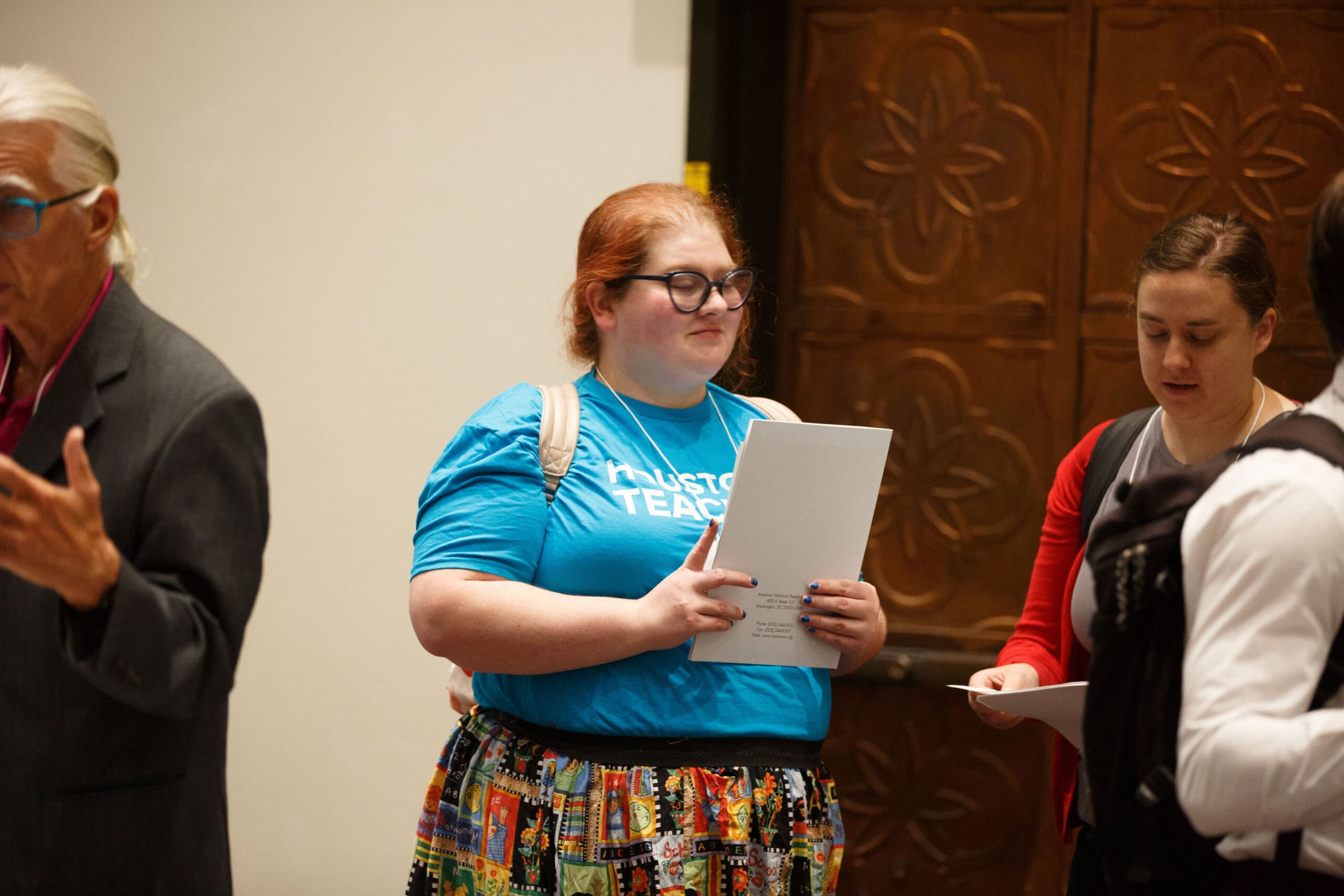 Woman with a set of papers in hand